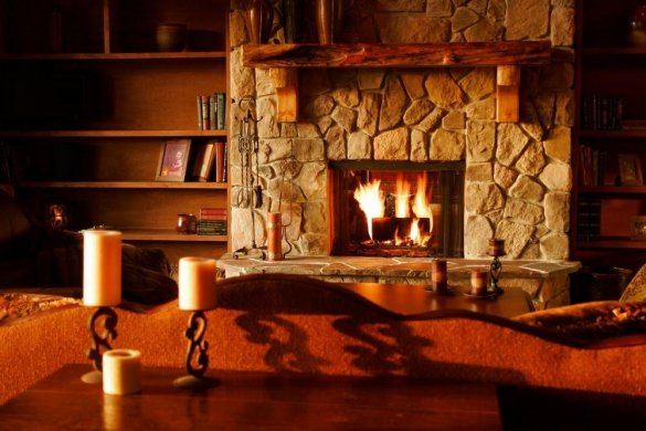 brown wooden table with white pillar candles