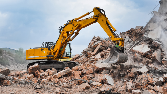 a bull dozer demolishing a home