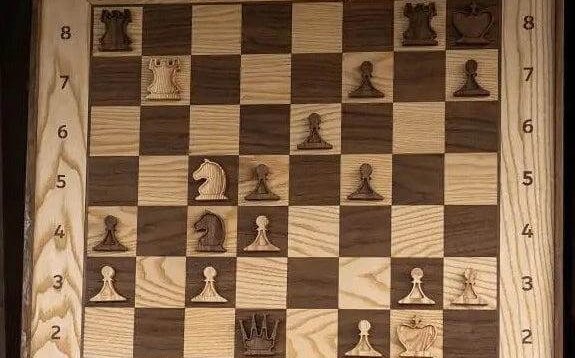 Close-up of a wall-mounted vertical chessboard with concealed hanging hardware