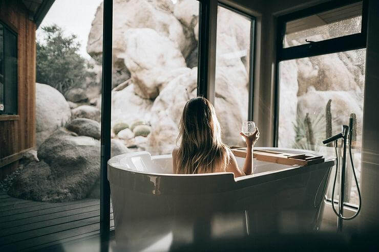 A woman is relaxing on a clean bathtub